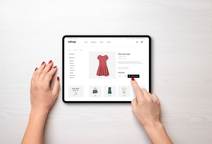 Online shopping with a tablet. Red women's dress on the e-commerce